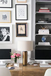 Gallery wall and shelves in white office space