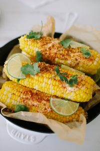 a pan of Mexican corn on the cob