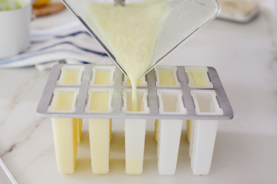 pouring popsicle mixture into molds