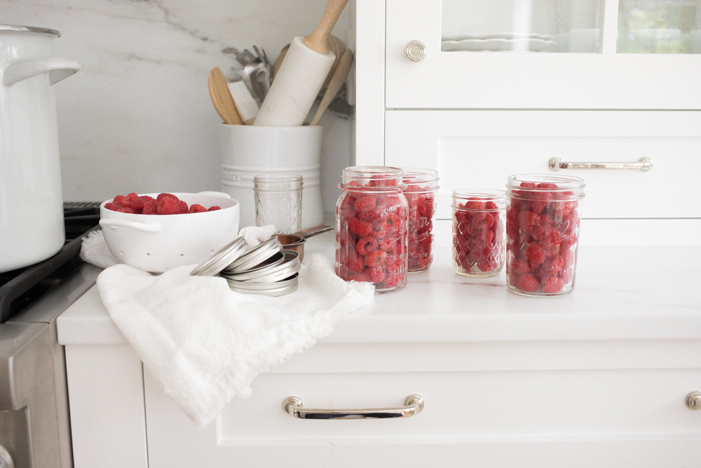 canning supplies and washed raspberries