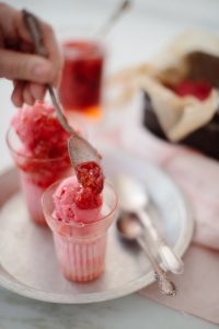 topping ice-cream with the raspberries