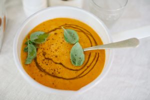tomato soup with drizzle of olive oil and basil