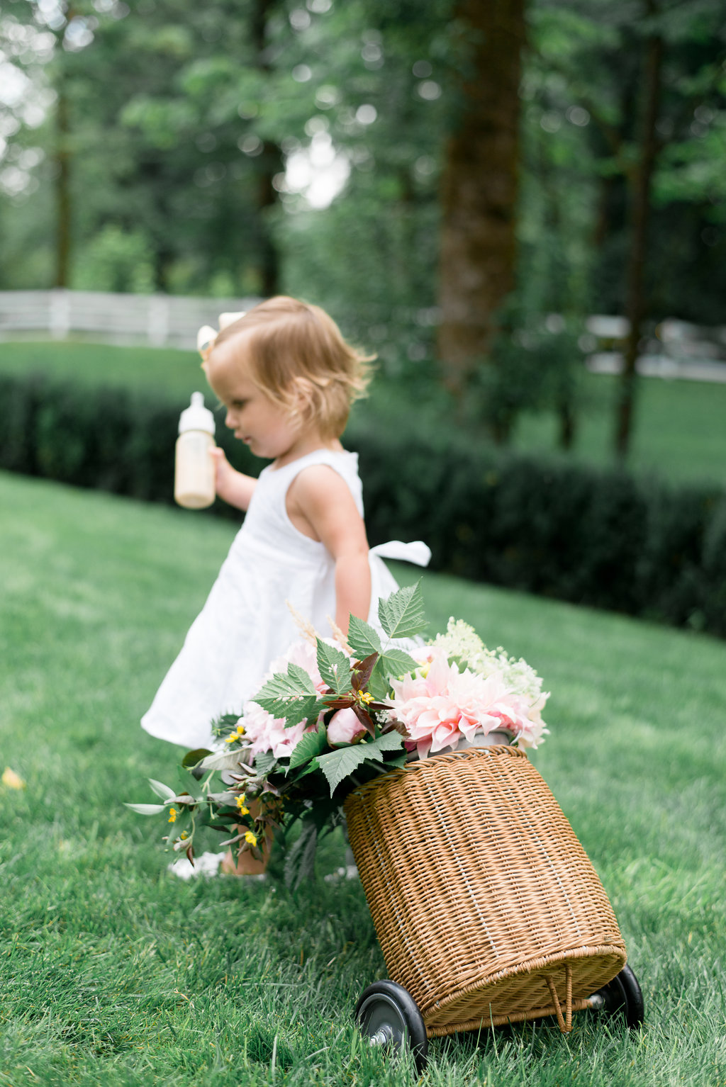 Lillya pulling a woven basket with fresh flowers 