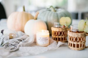 pumpkins, burning candle and apple cider