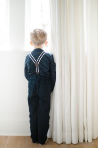 toddler boy looking out window