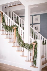 stairs with garland on banister with bows