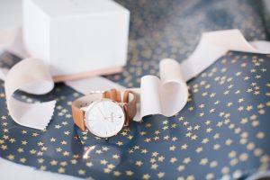 watch on star wrapping paper with ribbon
