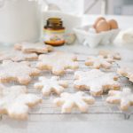 snowflake cookies on cooling rack , ingredients in background