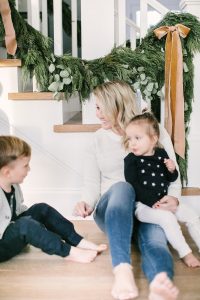 mom and son and daughter sitting on floor christmas time
