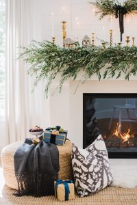 fireplace set up with gingerbread house on mantels