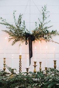 brass candlesticks and wreath
