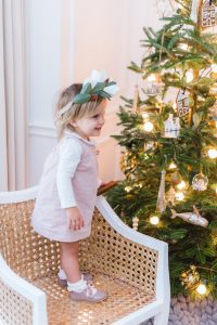 little girl on dinning chair, tree behind