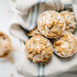 close up of banana muffins in tin with a linen napkin