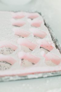 heart shaped marshmallows cut out of large baking sheet full of marshmallow