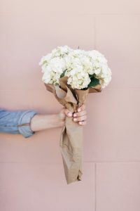 hand holding bouquet of flowers