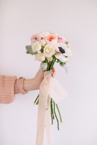 handing holding bouquet