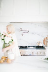 women holding flowers in airy bright kitchen