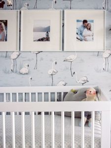 baby nursery with blue flamingo wallpaper