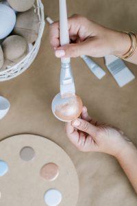 women painting paper eggs