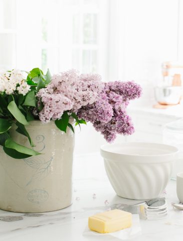 lilacs in crock on marble countertop