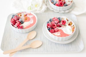 berry smoothie bowls on tray