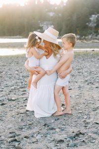 mom on beach with two kids