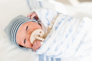 newborn in wave blanket