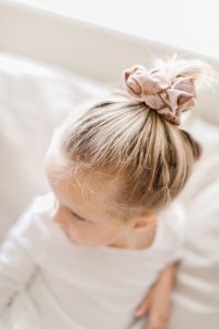 little girl with scrunchie in her hair