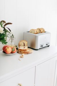 toast in toaster on white counter
