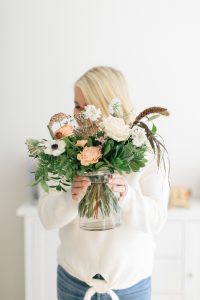 women holding vase of fall florals