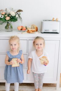 two little girls smiling by breakfast station