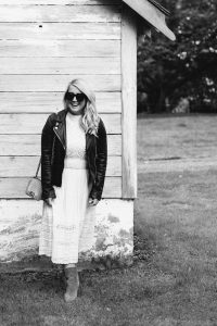 women by a barn with leather jacket on