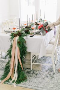 holiday table setting with live greenery down the middle