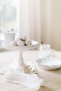 snowball cookies on white cake stand