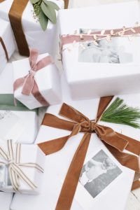 pretty white wrapped gifts with velvet ribbon and photo gift tags