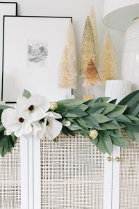 white paper magnolias in a paper garland