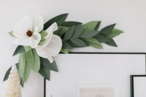 white paper magnolias and greenery