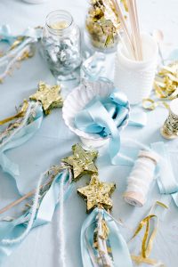 table display with star wands blue and white ribbons