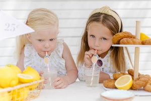 two girls drinking lemonade