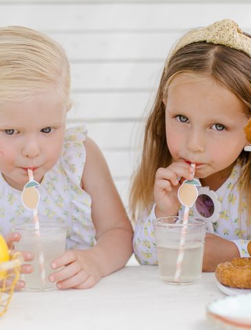 two young girls drinking lemonade