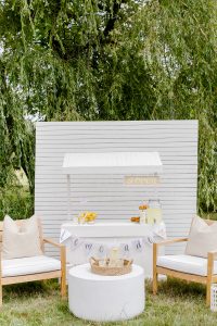 lemonade booth with chairs and tables in front
