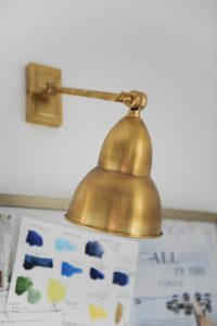 brass lamp on white wall
