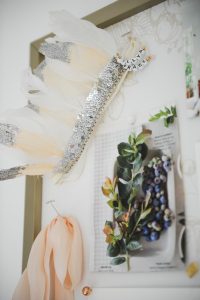 inspiration board with a sequence feather headband ribbon and floral images