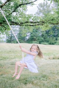 Girl on tree swing