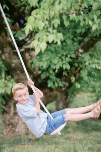 Young boy on a tree swing