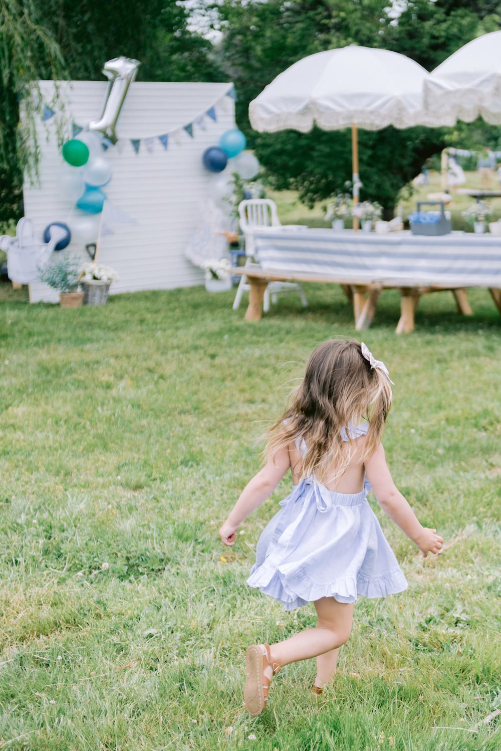 small girl in cute dress running in grass