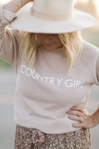 blonde woman wearing country girl crew sweater