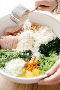 Combining Ingredients for Loaded Green Chicken Meatballs in Bowl