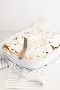 iced Cinnamon Buns in a porcelain baker