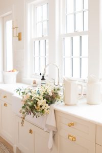 Flower bouquet in kitchen sink by window